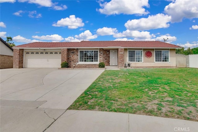 ranch-style house featuring a tile roof, fence, an attached garage, driveway, and a front lawn