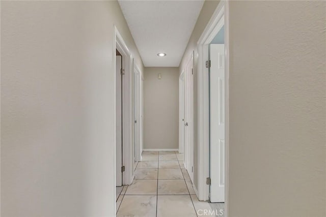 corridor with light tile patterned floors