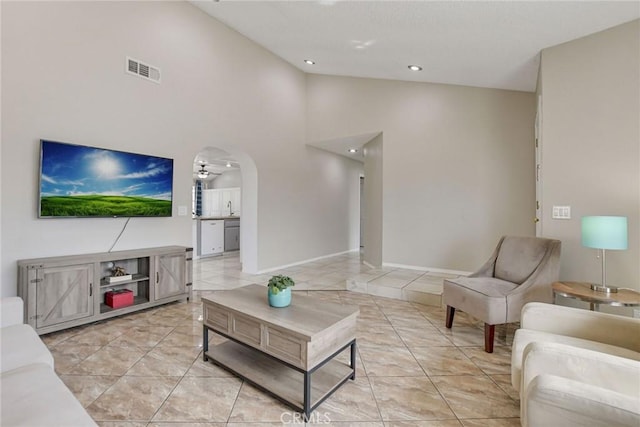 living area with light tile patterned flooring, a ceiling fan, baseboards, visible vents, and recessed lighting