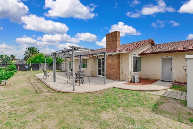 rear view of property with stucco siding, fence, a patio, a pergola, and a chimney