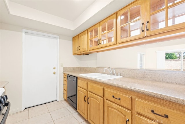 kitchen featuring light tile patterned floors, glass insert cabinets, black dishwasher, a tray ceiling, and a sink