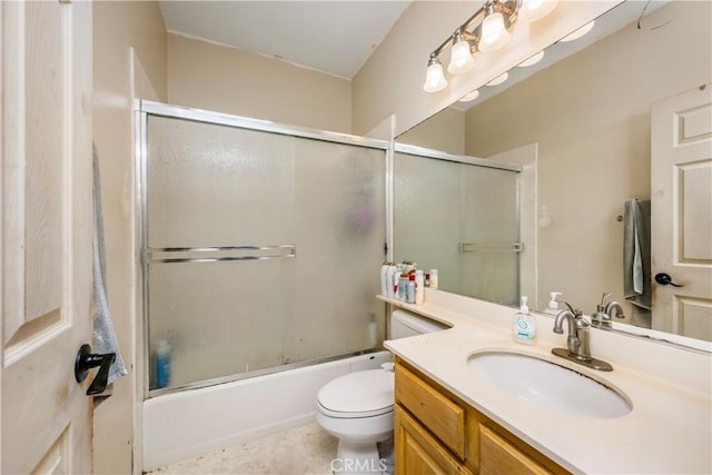 bathroom with toilet, vanity, and enclosed tub / shower combo