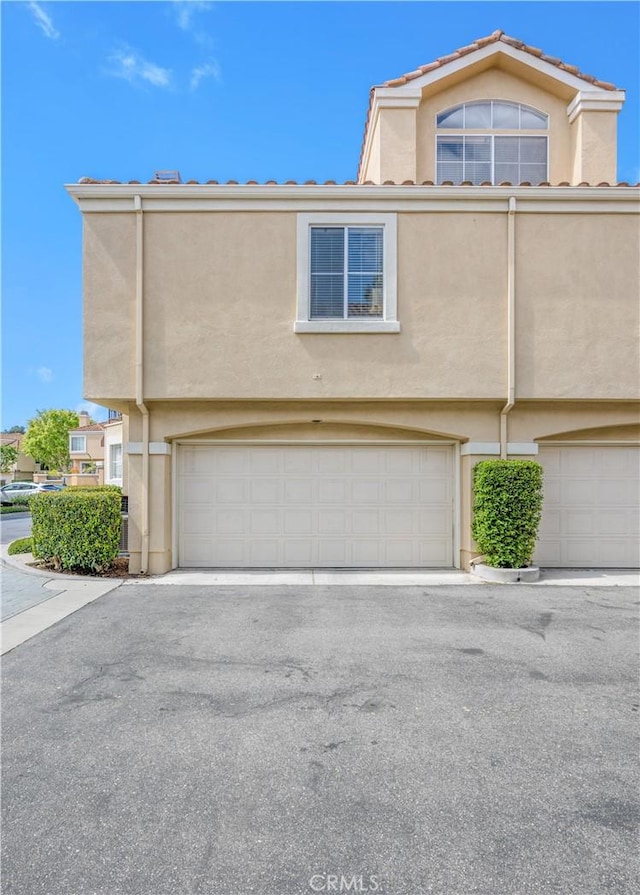 view of property with stucco siding and an attached garage