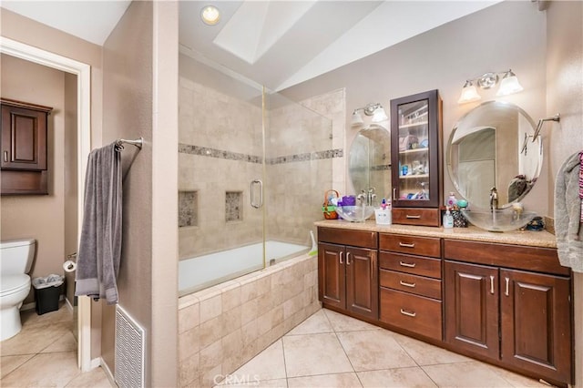 bathroom with tile patterned flooring, lofted ceiling, toilet, visible vents, and double vanity