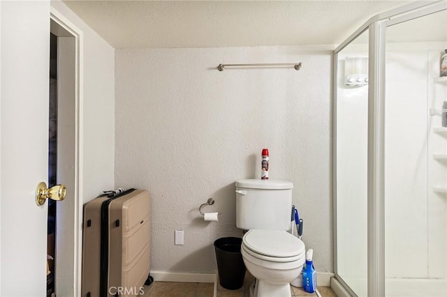 31662 Panorama Dr, Running Springs, CA 92382 - full bathroom featuring a shower stall, toilet, baseboards, and tile patterned flooring