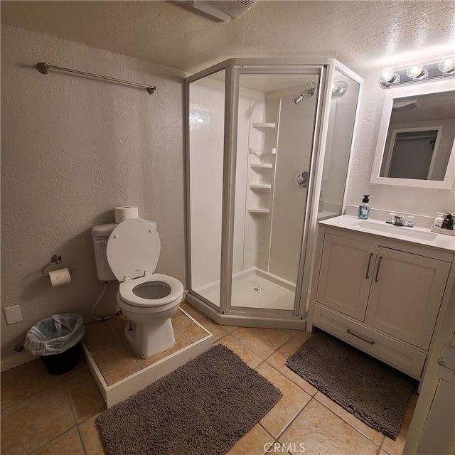 31662 Panorama Dr, Running Springs, CA 92382 - bathroom featuring tile patterned flooring, toilet, a stall shower, a textured wall, and a textured ceiling