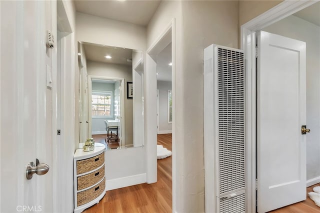 1012 S 11th St, San Jose, CA 95112 - corridor with a heating unit, light wood-style flooring, and baseboards