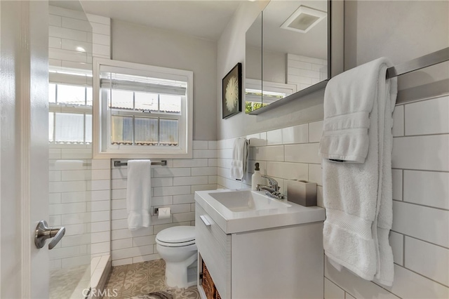 1012 S 11th St, San Jose, CA 95112 - bathroom featuring tile walls, toilet, tile patterned floors, and vanity
