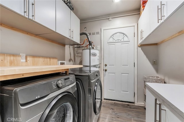 1012 S 11th St, San Jose, CA 95112 - laundry area featuring independent washer and dryer, cabinet space, light wood finished floors, and water heater