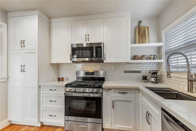 1012 S 11th St, San Jose, CA 95112 - kitchen with stainless steel appliances, a sink, decorative backsplash, and light countertops