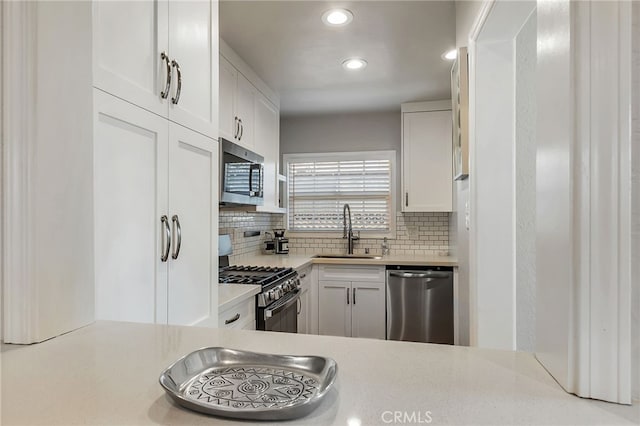 1012 S 11th St, San Jose, CA 95112 - kitchen with stainless steel appliances, a sink, decorative backsplash, light countertops, and recessed lighting