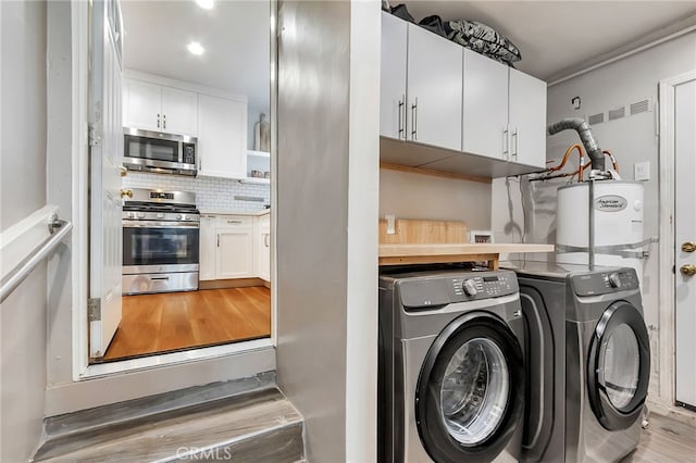 1012 S 11th St, San Jose, CA 95112 - clothes washing area with washing machine and clothes dryer, light wood-type flooring, water heater, and recessed lighting