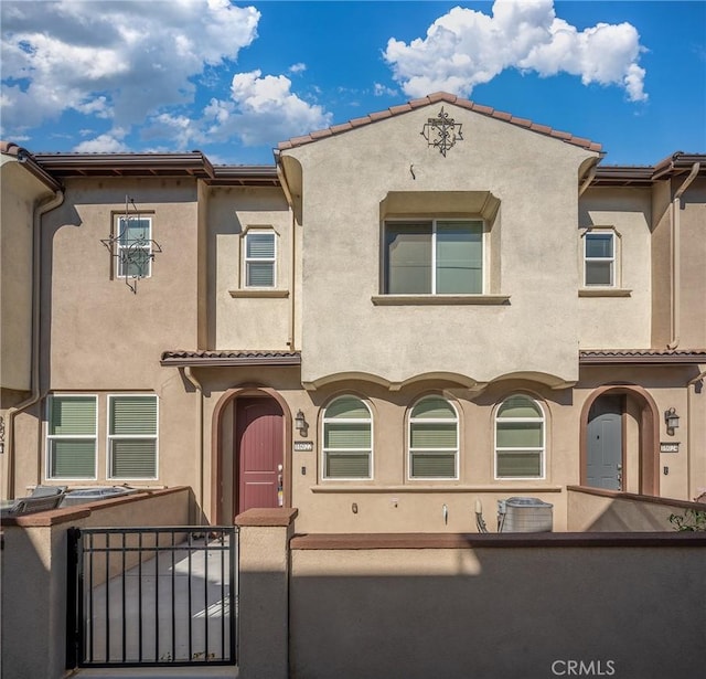 16022 Voyager Ave, Chino, CA 91708 - view of front of home featuring stucco siding, a fenced front yard, a gate, and a tile roof