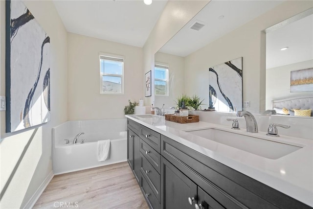 16022 Voyager Ave, Chino, CA 91708 - bathroom featuring wood finished floors, a bath, and double vanity
