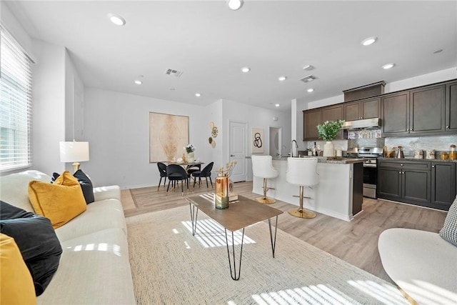 16022 Voyager Ave, Chino, CA 91708 - living room featuring light wood finished floors and recessed lighting