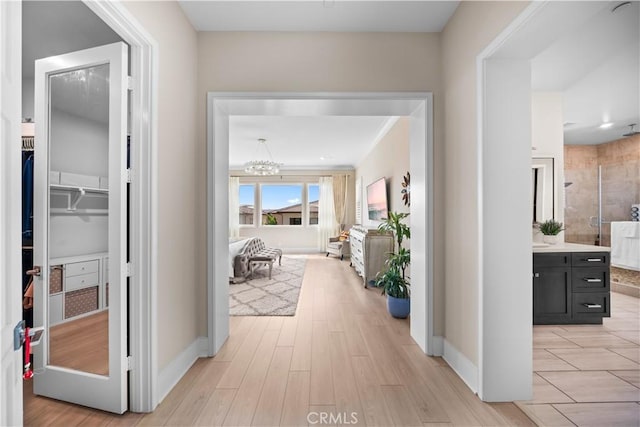 107 Balance, Irvine, CA 92618 - hallway with a chandelier and light wood-type flooring