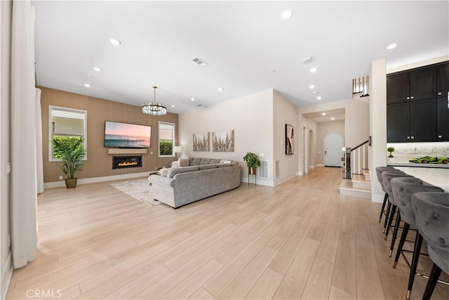 107 Balance, Irvine, CA 92618 - living area featuring light wood finished floors, stairs, recessed lighting, a chandelier, and a glass covered fireplace