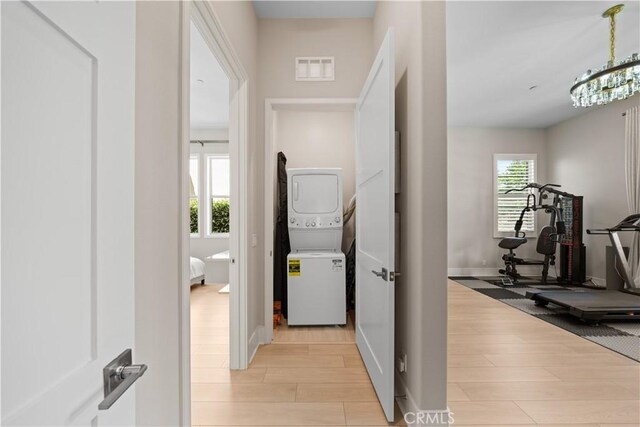 107 Balance, Irvine, CA 92618 - washroom with stacked washer / drying machine, light wood-style floors, and a chandelier