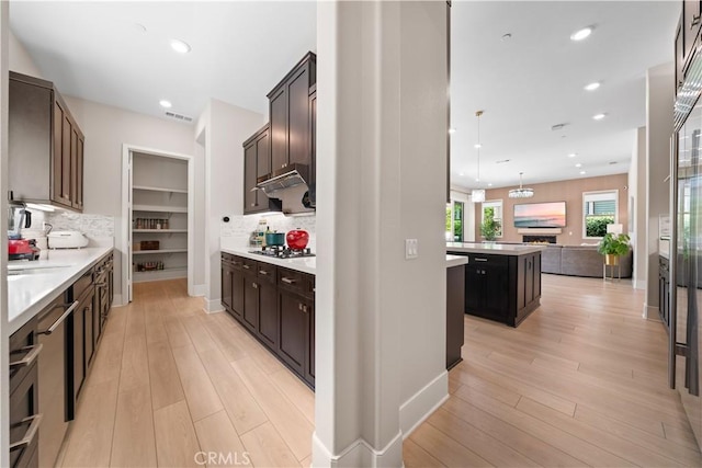 107 Balance, Irvine, CA 92618 - kitchen featuring light wood-type flooring, tasteful backsplash, light countertops, open floor plan, and recessed lighting