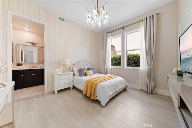 107 Balance, Irvine, CA 92618 - bedroom with a chandelier, light wood finished floors, wallpapered walls, and ensuite bath