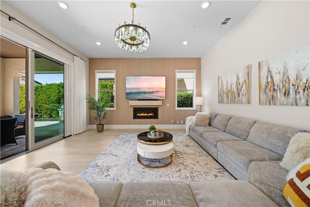 107 Balance, Irvine, CA 92618 - living area featuring wood finished floors, recessed lighting, a chandelier, and a glass covered fireplace