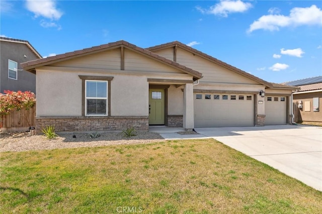 view of front of home featuring stone siding, fence, a garage, a front lawn, and driveway