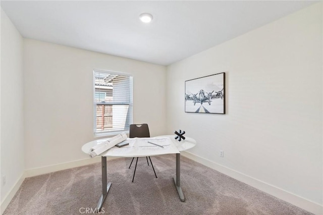 carpeted home office with baseboards