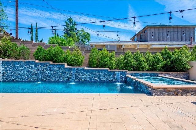 view of swimming pool featuring a pool with connected hot tub