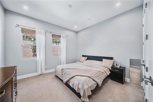 bedroom featuring recessed lighting, light carpet, and baseboards