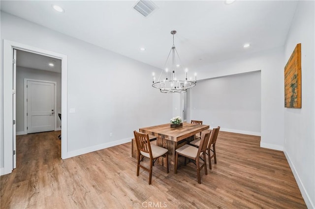 dining room with recessed lighting, wood finished floors, an inviting chandelier, baseboards, and visible vents