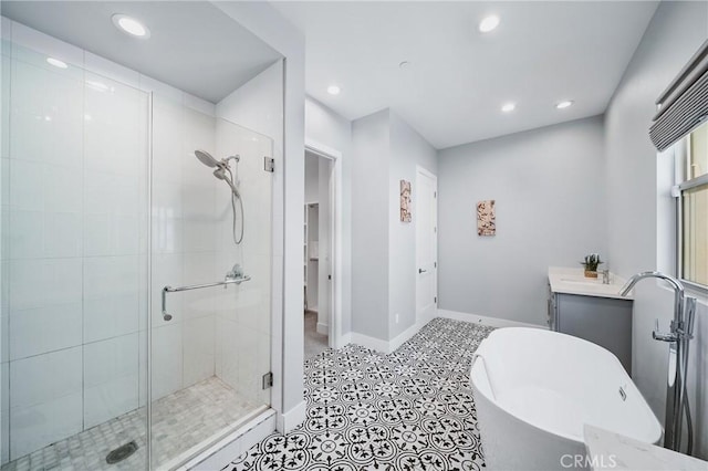 bathroom with vanity, recessed lighting, a freestanding bath, and a stall shower