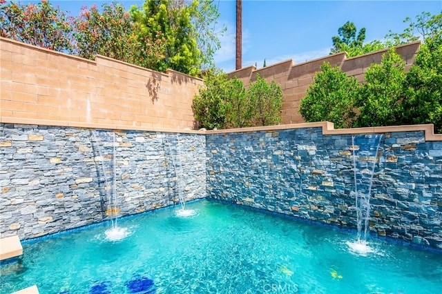 view of pool featuring fence