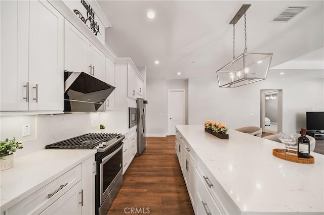 kitchen featuring recessed lighting, exhaust hood, appliances with stainless steel finishes, white cabinetry, and visible vents