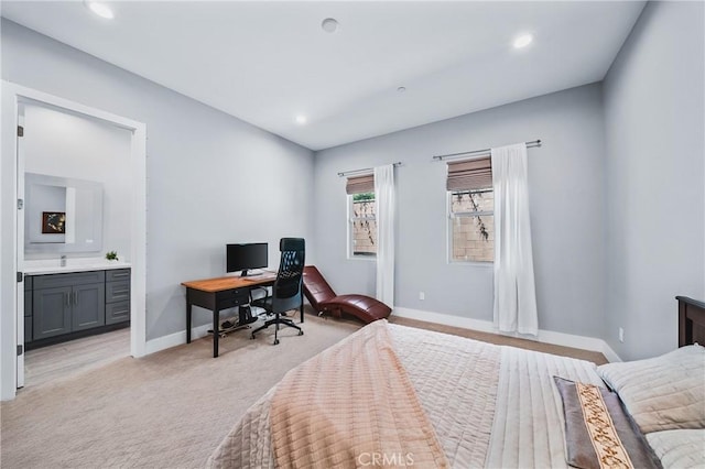 bedroom with recessed lighting, connected bathroom, light carpet, a sink, and baseboards