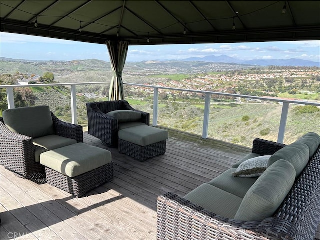 wooden terrace with a gazebo and a mountain view
