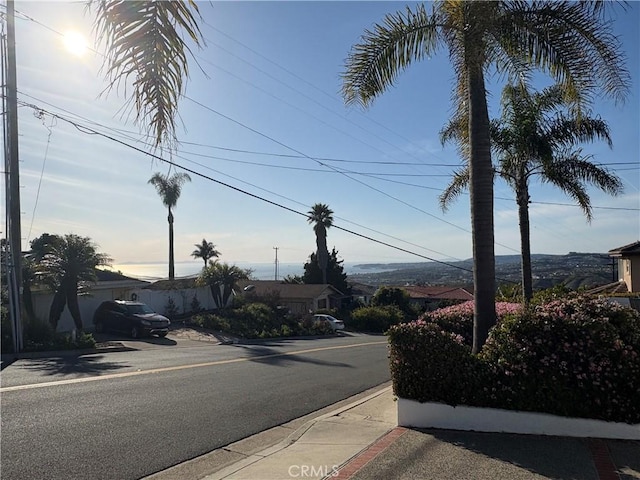 view of street with sidewalks and curbs