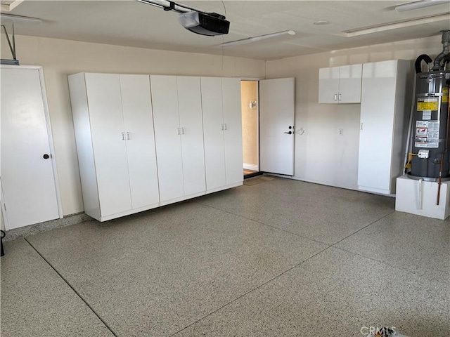 garage with gas water heater and a garage door opener