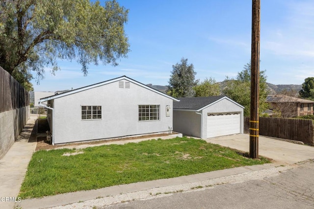 single story home featuring a garage, stucco siding, a front lawn, and fence