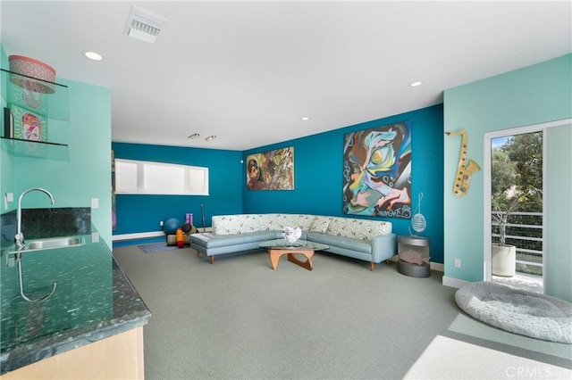 living room featuring visible vents, baseboards, recessed lighting, and carpet floors