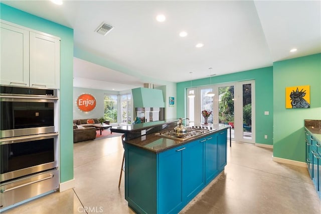 kitchen with concrete floors, visible vents, recessed lighting, a warming drawer, and appliances with stainless steel finishes