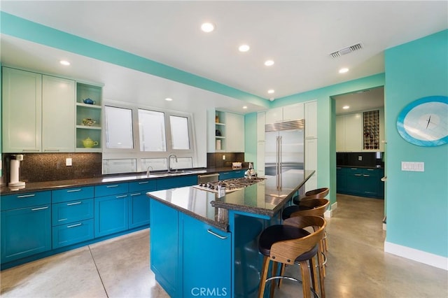 kitchen featuring visible vents, decorative backsplash, open shelves, and stainless steel appliances