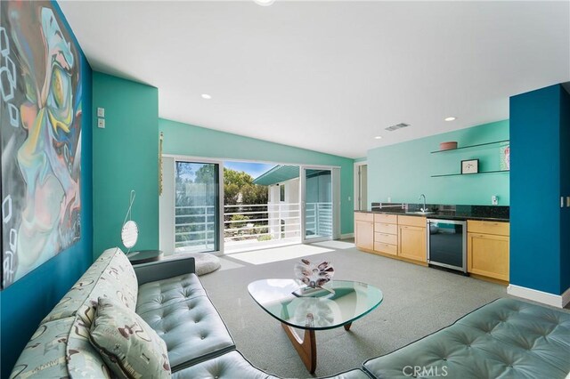living area featuring baseboards, wet bar, light carpet, recessed lighting, and visible vents