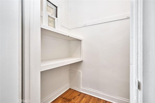 walk in closet featuring dark wood-style flooring