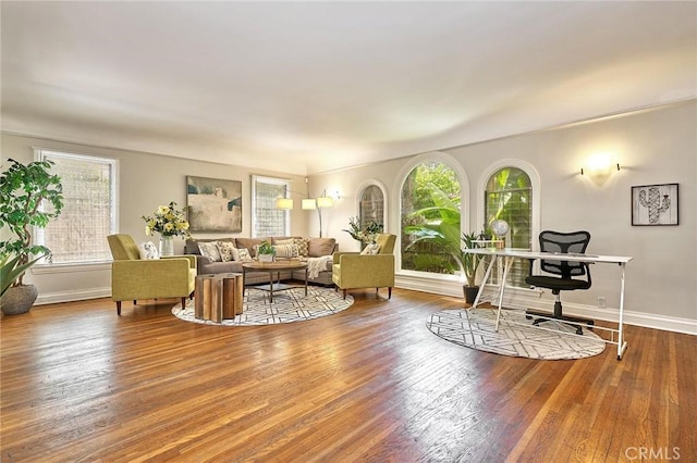 living room with baseboards and wood finished floors