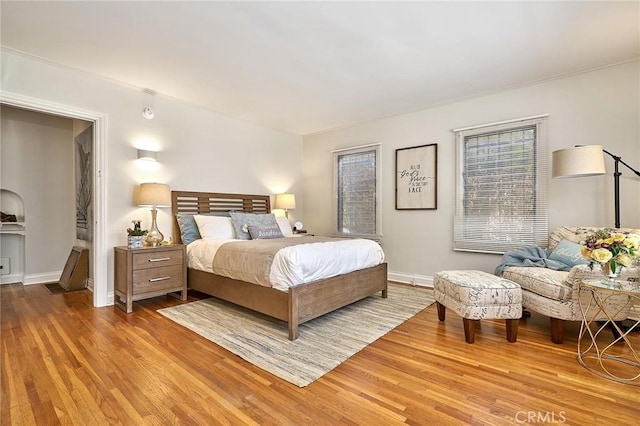 bedroom with baseboards and wood finished floors