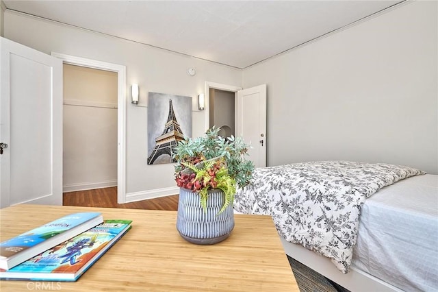 bedroom featuring baseboards and wood finished floors