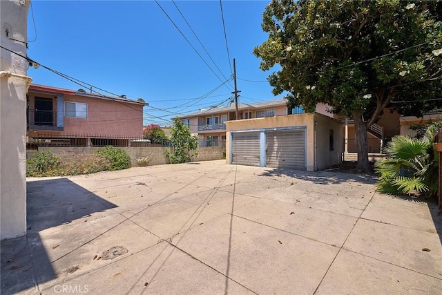 exterior space featuring an outbuilding, a garage, and fence