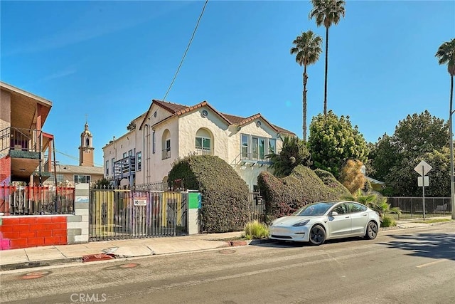 view of front of property with stucco siding and fence