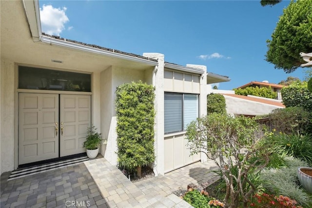 property entrance with stucco siding