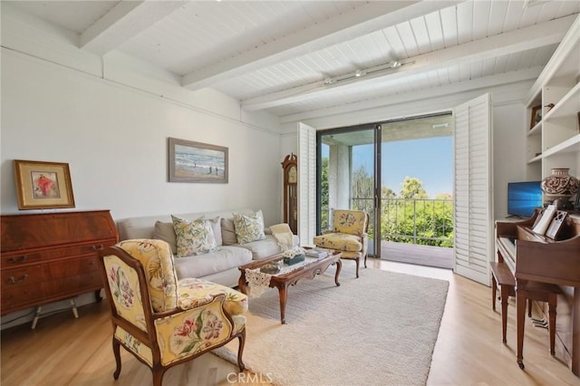 living room with light wood finished floors, beamed ceiling, and wooden ceiling